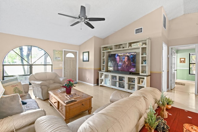 living room featuring ceiling fan, a textured ceiling, and high vaulted ceiling