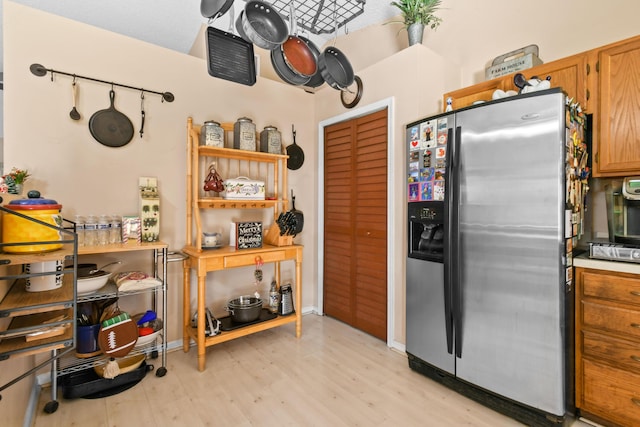 kitchen featuring stainless steel fridge with ice dispenser and light wood-type flooring