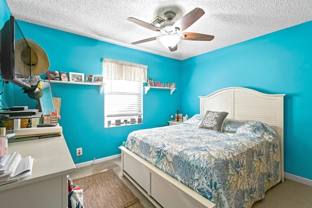 carpeted bedroom with a textured ceiling and ceiling fan