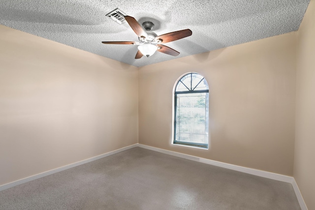 empty room featuring ceiling fan and a textured ceiling