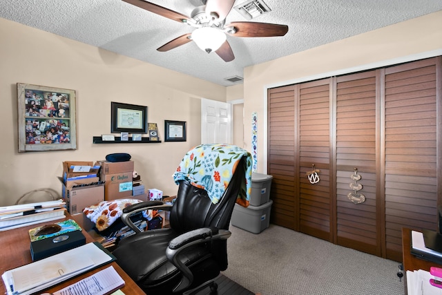 home office with carpet flooring, a textured ceiling, and ceiling fan