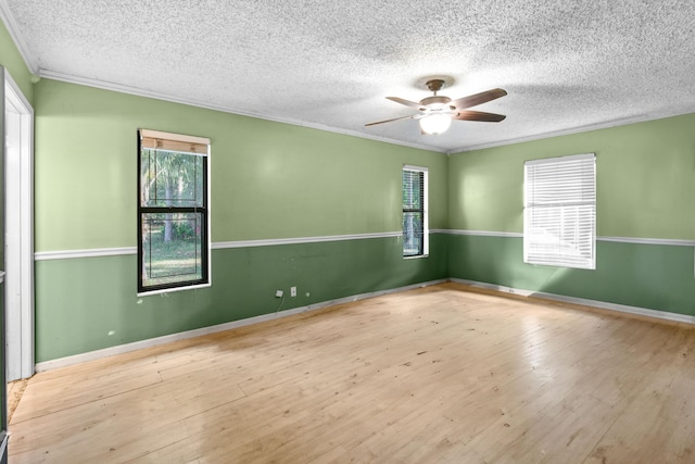 unfurnished room with ceiling fan, ornamental molding, a textured ceiling, and light hardwood / wood-style flooring