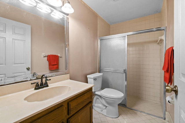 bathroom featuring tile patterned flooring, vanity, an enclosed shower, and toilet