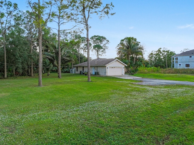 view of front of property featuring a garage and a front yard