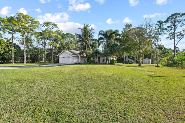 view of front of property featuring a front yard and a garage