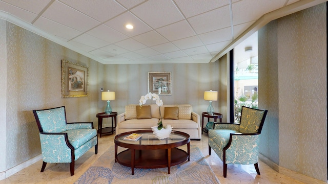 living area featuring a paneled ceiling