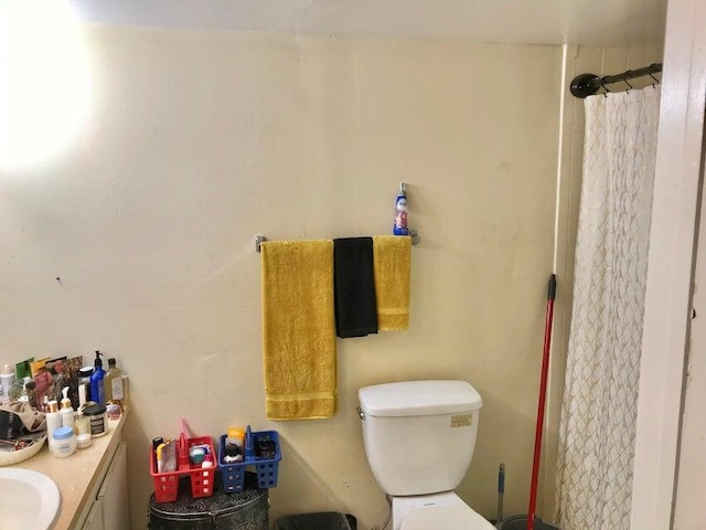 bathroom with vanity, toilet, and curtained shower