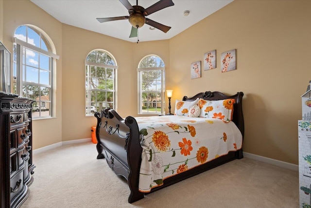 bedroom featuring ceiling fan and light colored carpet