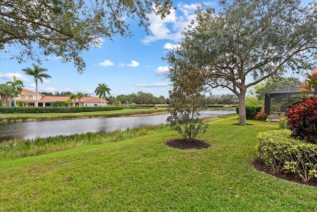 view of yard featuring a lanai and a water view