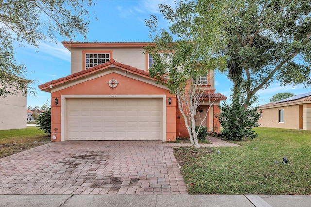 mediterranean / spanish-style house featuring a front lawn and a garage