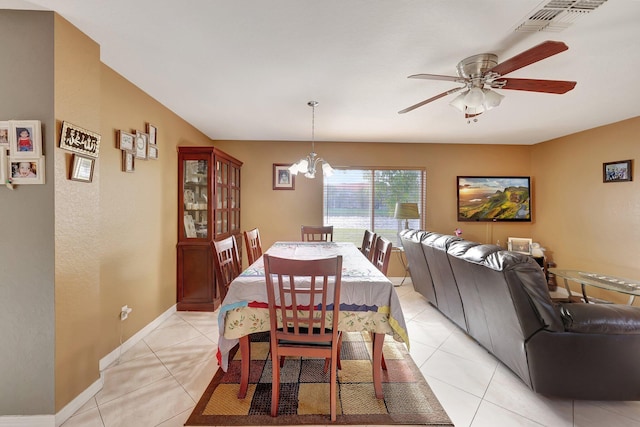 dining room with light tile patterned flooring and ceiling fan with notable chandelier