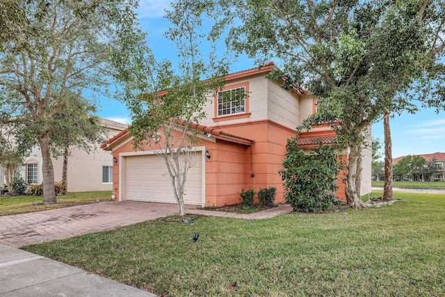 view of front of home featuring a front yard and a garage