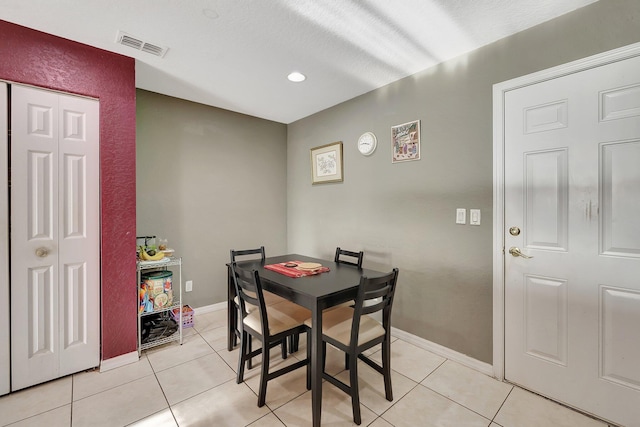 dining area with light tile patterned floors