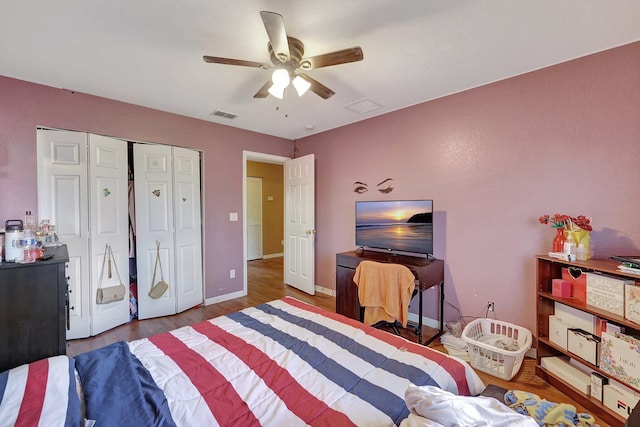 bedroom with a closet, ceiling fan, and dark wood-type flooring