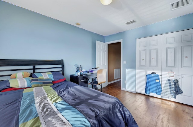 bedroom featuring dark hardwood / wood-style flooring and a closet