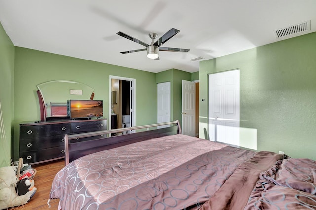 bedroom with ceiling fan and light hardwood / wood-style floors