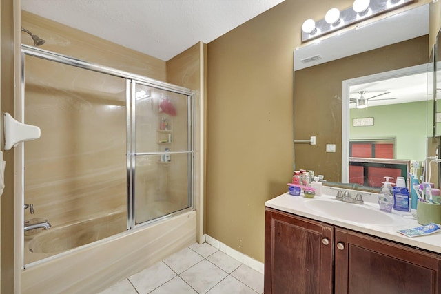 bathroom featuring tile patterned floors, ceiling fan, vanity, and bath / shower combo with glass door