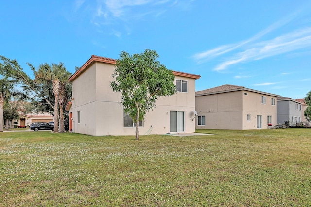 rear view of house with a yard