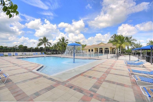 view of swimming pool featuring pool water feature and a patio area