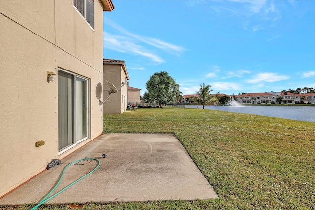 view of yard with a patio area and a water view