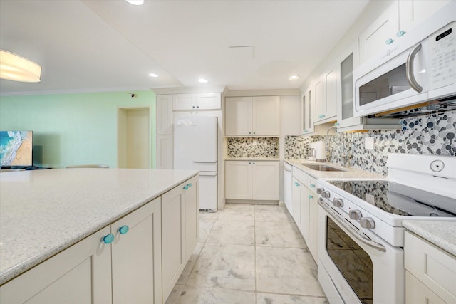 kitchen with white cabinets, crown molding, white appliances, and backsplash