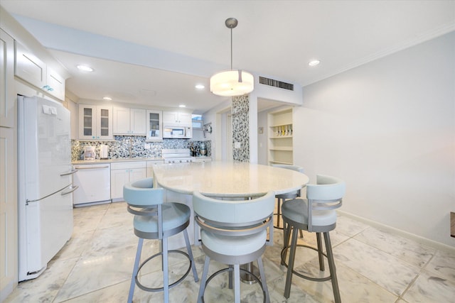 kitchen featuring tasteful backsplash, light countertops, visible vents, white cabinets, and white appliances