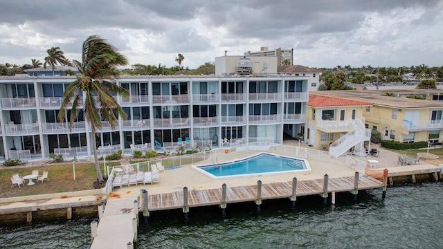 back of property featuring a water view