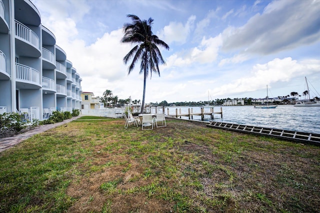 dock area featuring a water view and a yard