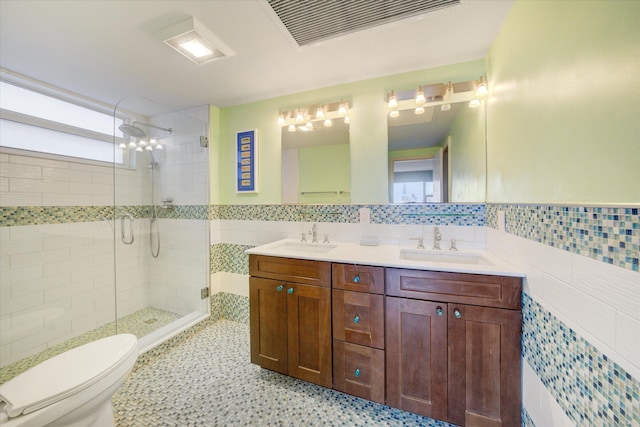 bathroom featuring tile walls, vanity, toilet, and walk in shower