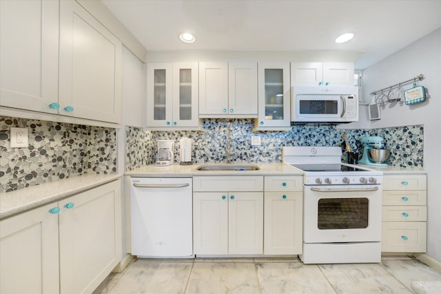 kitchen featuring white cabinetry, sink, white appliances, and decorative backsplash