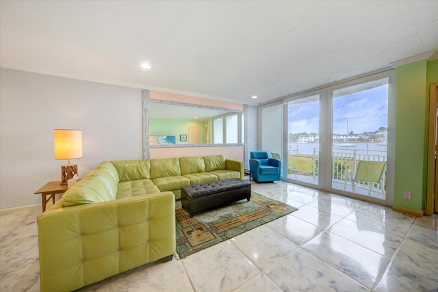 living room with a water view, ornamental molding, and floor to ceiling windows