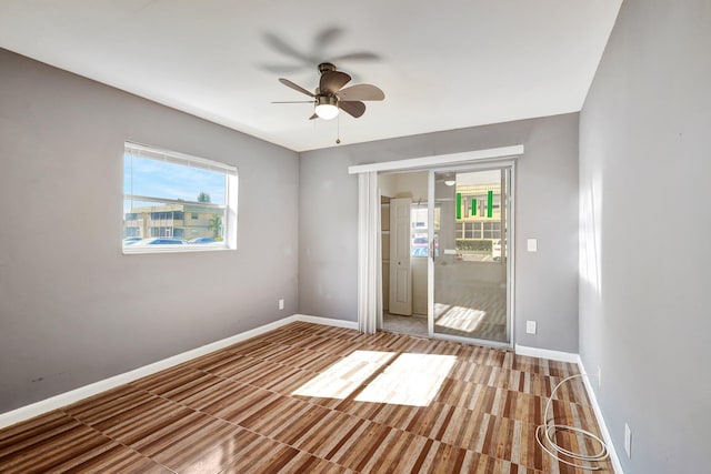 unfurnished bedroom with ceiling fan and multiple windows