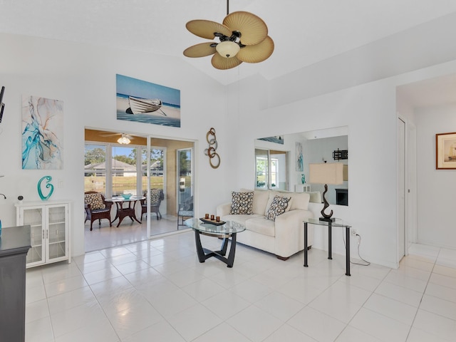 living room with high vaulted ceiling, light tile patterned flooring, and a wealth of natural light