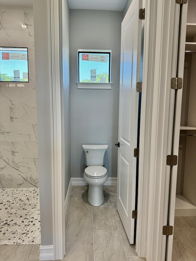 13200 SE US Highway 441, Okeechobee, FL 34974 - full bathroom with marble finish flooring, tiled shower, toilet, and baseboards