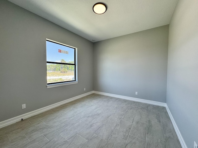 13200 SE US Highway 441, Okeechobee, FL 34974 - spare room with a textured ceiling and baseboards