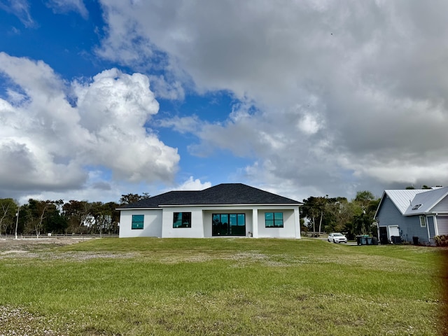 rear view of property with a yard