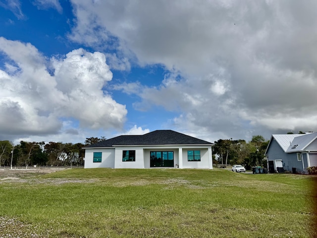 13200 SE US Highway 441, Okeechobee, FL 34974 - rear view of property with a lawn and stucco siding