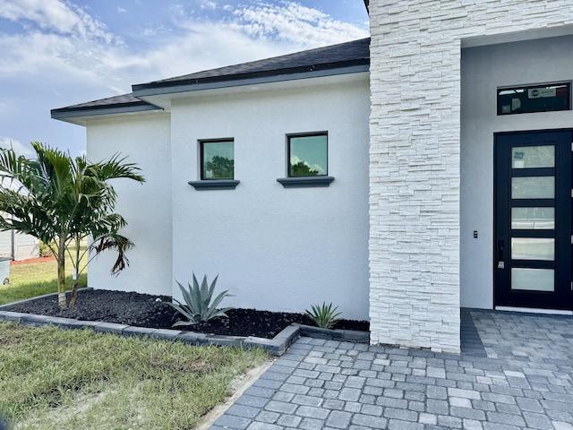13200 SE US Highway 441, Okeechobee, FL 34974 - view of side of property featuring stone siding and stucco siding