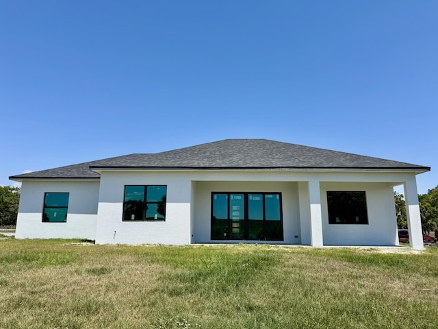 13200 SE US Highway 441, Okeechobee, FL 34974 - back of house with a lawn, roof with shingles, and stucco siding
