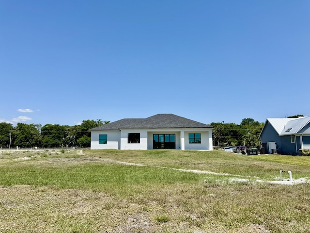 13200 SE US Highway 441, Okeechobee, FL 34974 - back of house featuring a lawn and stucco siding