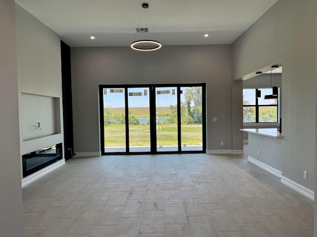 13200 SE US Highway 441, Okeechobee, FL 34974 - unfurnished living room with baseboards and recessed lighting