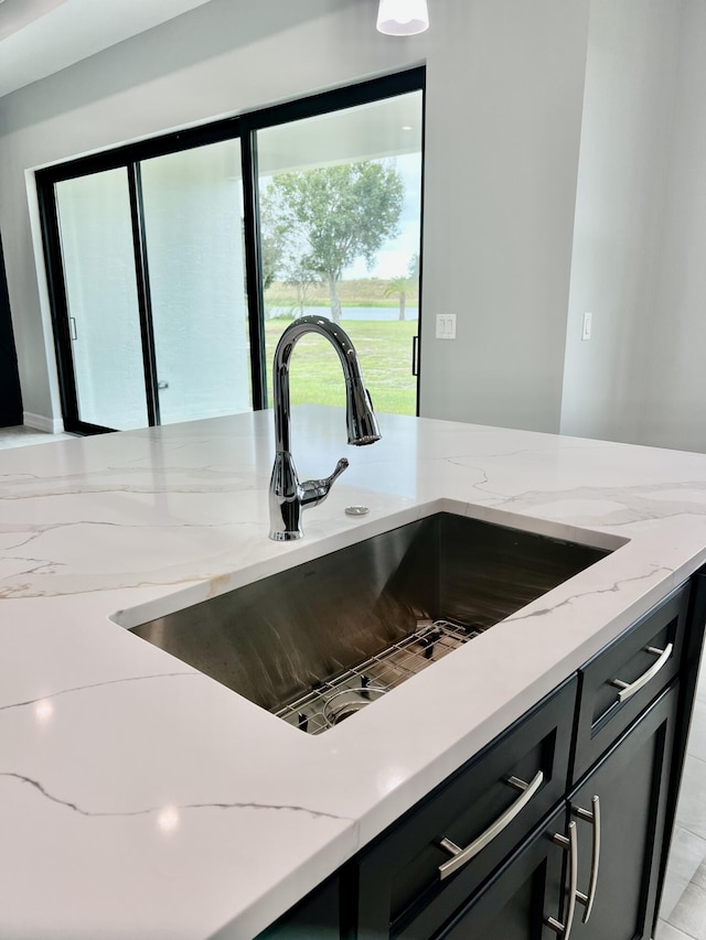 room details with light stone countertops and sink