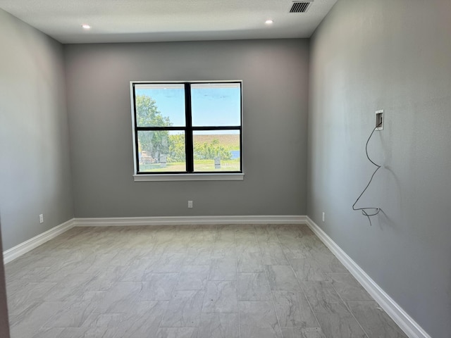 13200 SE US Highway 441, Okeechobee, FL 34974 - unfurnished room with baseboards, light marble finish floors, and recessed lighting