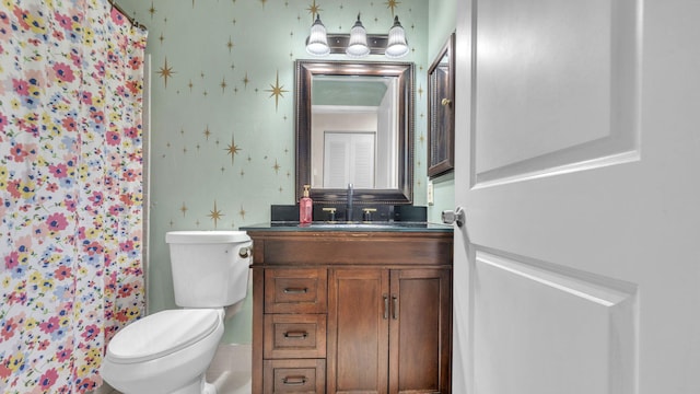 bathroom featuring vanity, toilet, and curtained shower