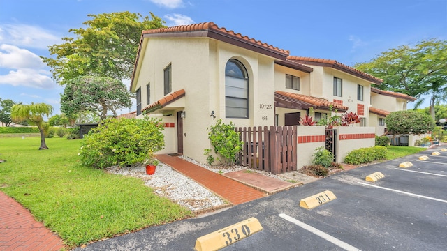 mediterranean / spanish-style house featuring a front lawn