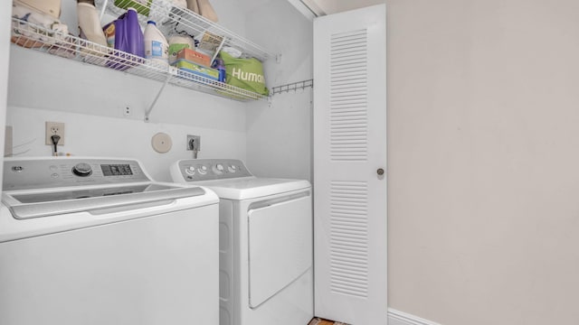 clothes washing area with washing machine and clothes dryer