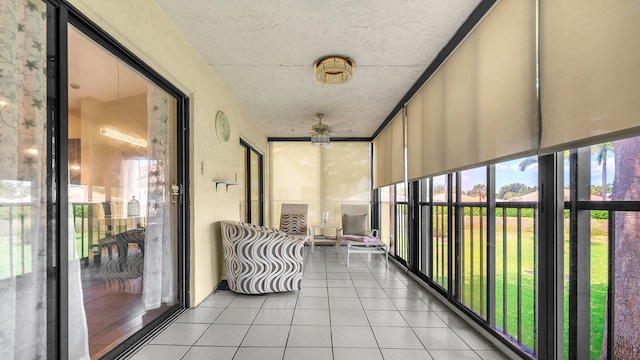 unfurnished sunroom featuring a wealth of natural light and ceiling fan