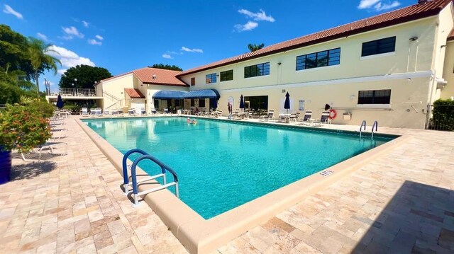 view of swimming pool with a patio