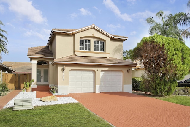 view of front facade with a garage and french doors