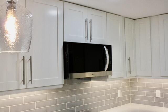 details with tasteful backsplash and white cabinets